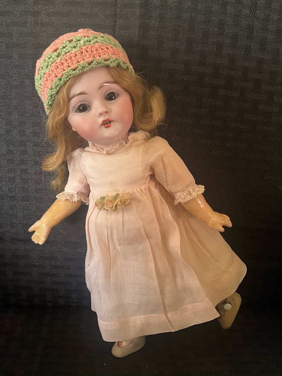 Rare to find 9.5” Kestner 143 ( pre mold # example) on petite bjb with straight wrists. Her facial painting is exquisite and brown sleep eyes give her such a soft look. Her original human hair wig is on a  plaster pate. She wears what I believe to be her factory  peachy blush organdy dress with antique undergarments. I have added an antique bakelite floral pin. She would look so dear in the arms of a larger bear. These rarely come along in this size. She is a gem. ~ $795