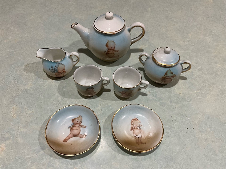 ~ 9 piece Rose O’Neill Germany tea set with gold trim. There is a craze line in the lid, it is not at all weak. Cups measure 1” tall.  As shown. What a cute set to display alongside your dolls and bears. ~ $65 postage depends on destination
