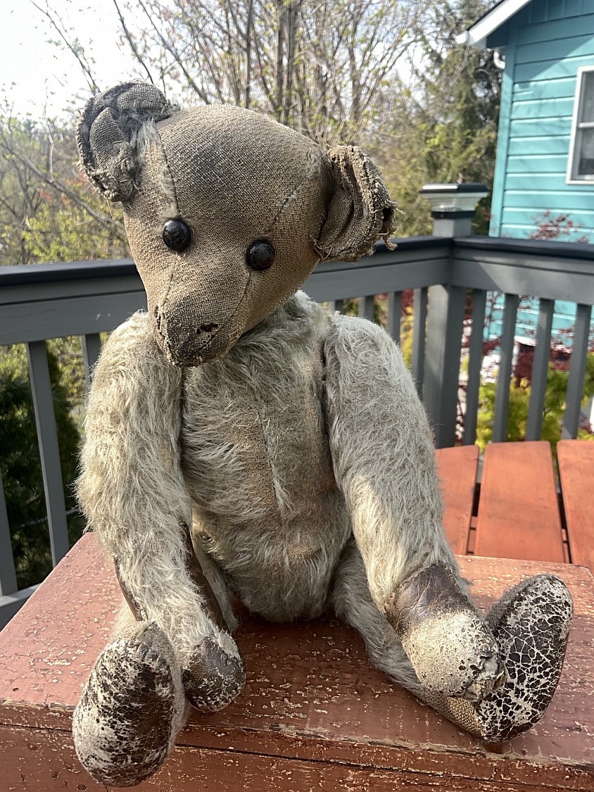 Early 13.5” Kapok filled mohair bear with photo provenance. Ted wears a navy wool nautical suit that has clearly been on him for most if not all of his life. It has saved the mohair on his body and limbs from being worn away like it is on his head. His pads have LONG ago been recovered with buttery soft leather. Ted has original boot button eyes. The accompanying photo appears to have been taken in the 1950’s or 60’s. The bear is clearly visible being held by his owner and wearing his navy wool suit. A charming snapshot of a lifelong friendship. $395 postage paid within the US International buyers please contact me for shipping cost